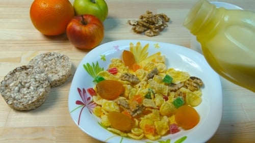Pouring Milk into Bowl of Corn Flakes