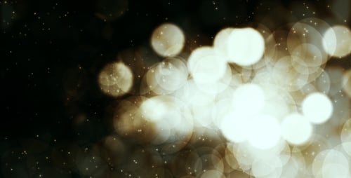 Shifting Golden Bokeh Lights with Twinkling Particles