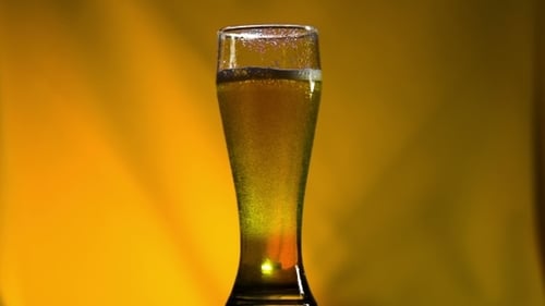 Golden Beverage Poured into Glass Close Up