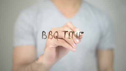 Man Writes 'BBQ Time' on Clear Surface