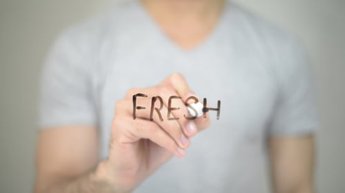 Hand Writing Fresh on Clear Surface