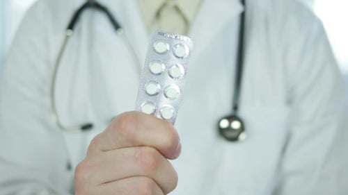 Doctor Holding Blister Pack of Pills in Hospital