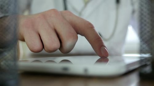 Doctor Using Tablet Device in Hospital Setting