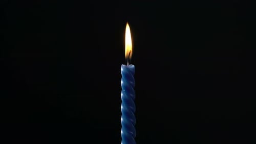 Single Pink Striped Birthday Candle on Black Background