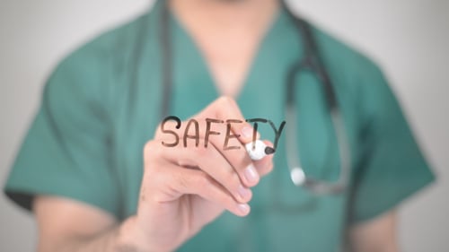 Healthcare Worker Writes Safety Message in Hospital Setting
