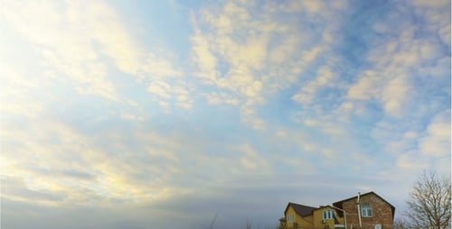 House on Hill with Golden Sky at Sunset