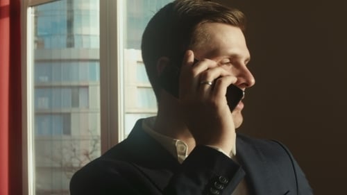 Man Talking on Phone in City Office