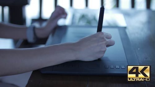 Designer Using Stylus and Tablet at Desk