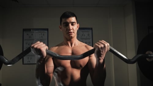 Muscular Man Doing Heavy Weight Exercise For Biceps