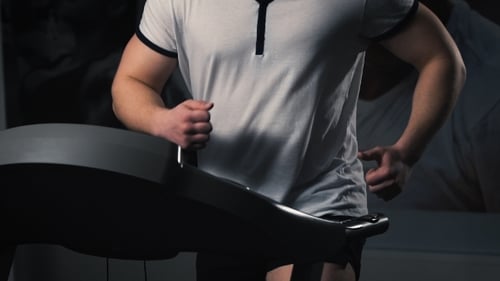 Man On Running Machine In Gym