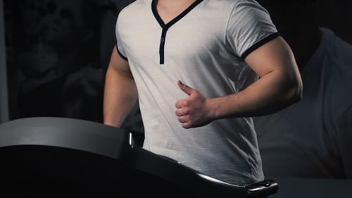 Man On Running Machine In Gym