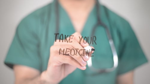 Medical Professional Writes Take Your Medicine Message