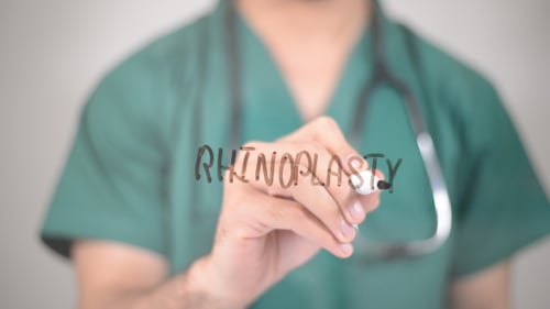 Medical Professional Writes Rhinoplasty for Cosmetic Surgery Concept