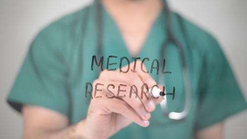 Doctor Writes Medical Research in Black Marker