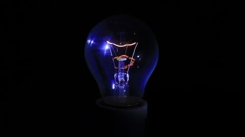 Light Bulb On Black Background