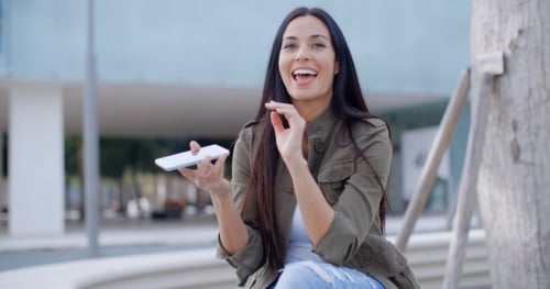 Young Woman Using Her Smartphone In Town