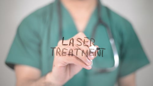Healthcare Provider Writing Laser Treatment on Screen