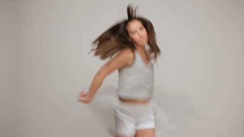 Brunette Woman Dancing with White Fabric