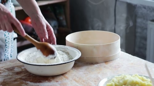 Mixing White Flour with Wooden Spoon in Bowl