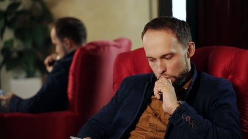 Businessman Looking To The Phone And Smoking Electronic Cigarette