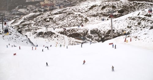 View From a Ski Lift Of Skiers Below On a Run