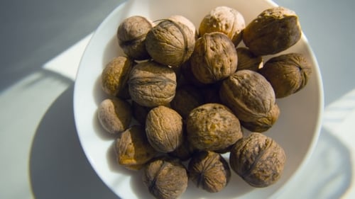 Bowl Full of Whole Walnuts in Shells