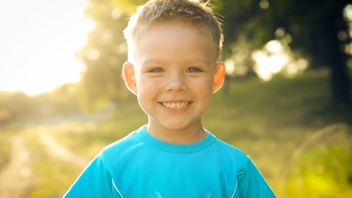 Portrait Of Smiling Boy On Sunset