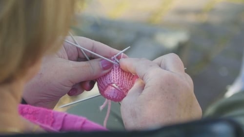 Woman's Hands Knitting Light Pink Yarn Close Up