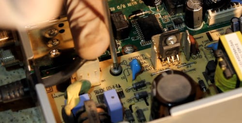 Servicing Computer Motherboard with Screwdriver Close Up
