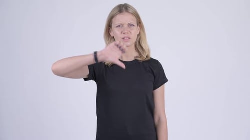 Woman Gives Thumbs Down Gesture of Disapproval