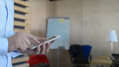 Man Using Smartphone in Modern Workplace