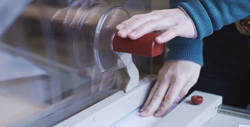 Person Cuts Paper with a Paper Cutter