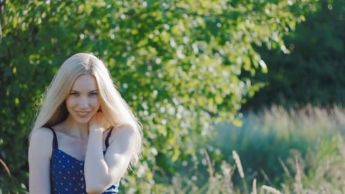 Beautiful Woman Posing in a Green Meadow