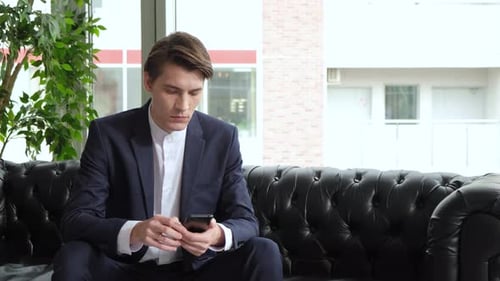 Professional Creative Man Sitting in Home Office Studio Using Smartphone, Man Using Mobile