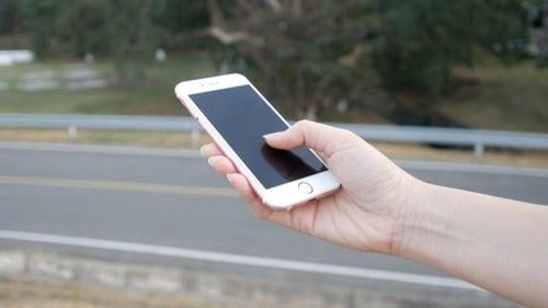 Hand Using Modern Smart Phone Outdoors Close Up