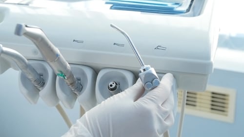 Hand Selecting Metal Dental Tool in Clinic