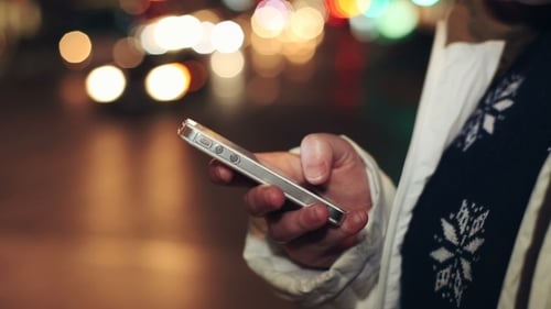Woman Using Smartphone in Urban Night Setting