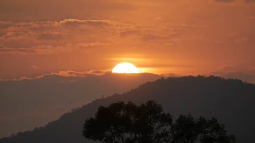 Dramatic Sunset Behind Dark Mountain Silhouette