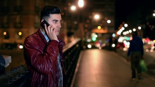 Young Man Talking on Phone at Night