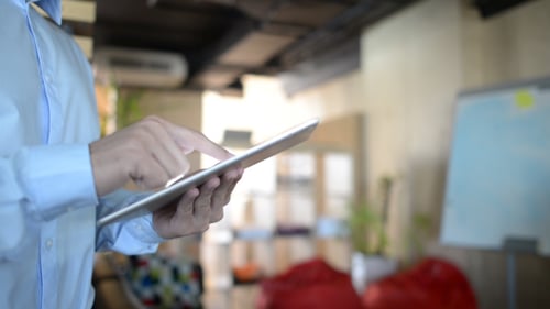 Man Using Tablet in Bright Modern Office