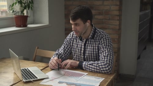 Young Adult Working from Home with Laptop