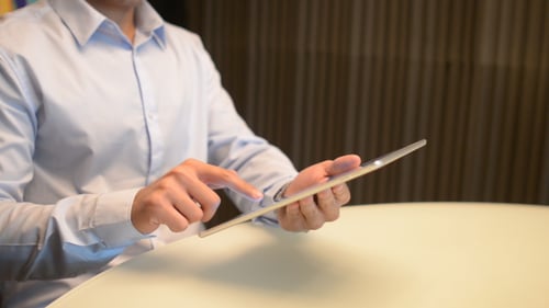 Man Using Tablet at Office Table