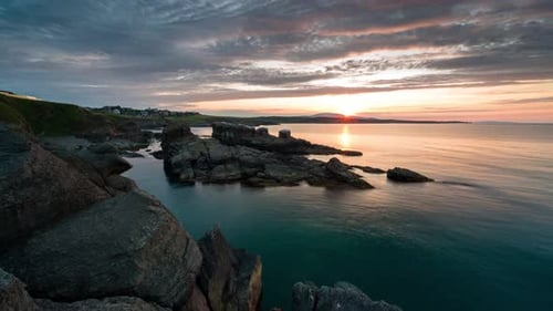 Colorful sunset sky at rocky coastline
