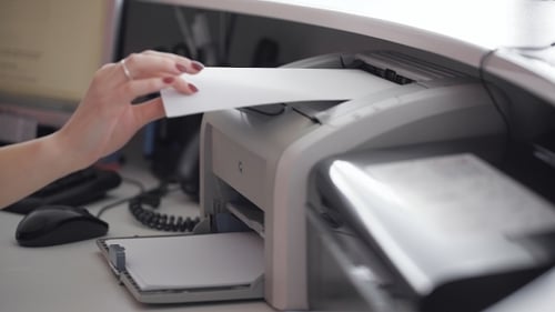 Business Woman Reaching Paper From Printer
