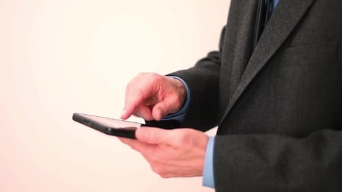 Man in Suit Using Digital Tablet Device
