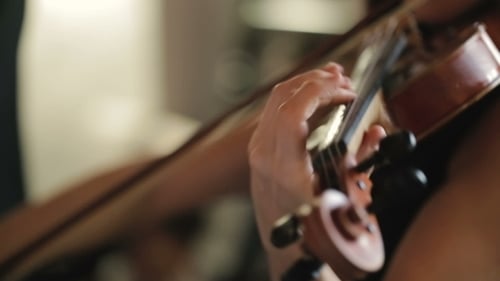 Woman playing violin in close up shot