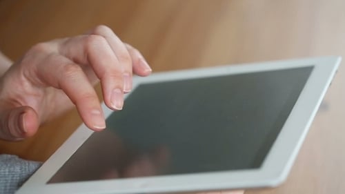 Hand Interacting with Tablet Device Close Up