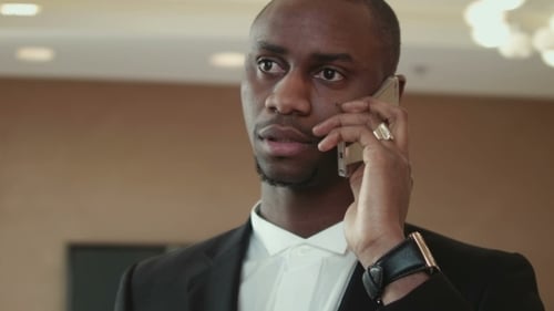 Man in Suit Speaking on Mobile Phone