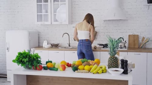Young Woman with Tablet in Bright Kitchen
