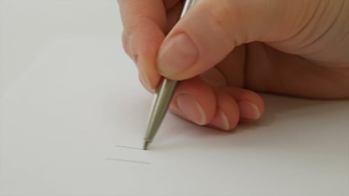 Hand Writes 'I Love You' Message on Paper